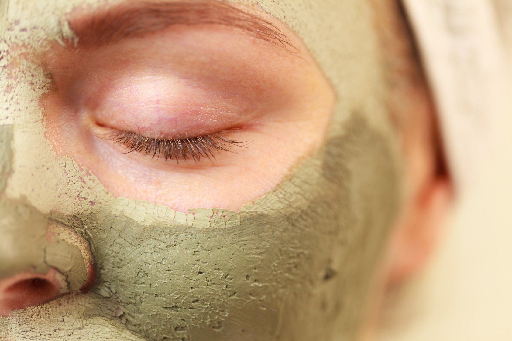 Woman face with green clay mud mask